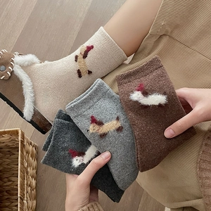 Detailed view of thick knitted socks featuring cute 3D flocked puppy motifs for winter