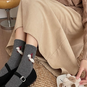 Detailed close-up of dark grey socks featuring a cute puppy embroidery and thick knit texture