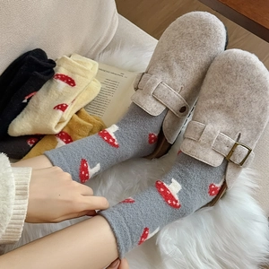Warm thermal wool socks for women featuring cute red mushroom patterns on grey cozy fabric