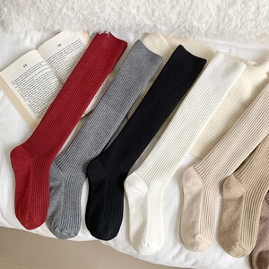 Detailed view of vertical striped knitted cashmere socks in various warm autumn colors