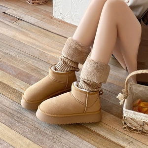 Thick knit leg warmers with faux fur trim paired with platform boots on wooden floor