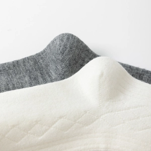Close-up of soft ribbed knit texture on white and grey cotton blend cashmere socks
