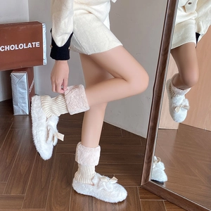 Detail of cream plush slippers with bow and matching thick knit faux fur leg warmers