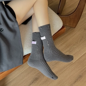 Thick dark grey cashmere blend ribbed socks with distressed holes and heart label