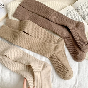 Detail of ribbed knit crew socks in earth tones showing thick warm fabric texture
