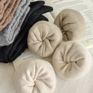 Detailed macro shot of thick rib-knit wool socks in various warm autumn earth tones