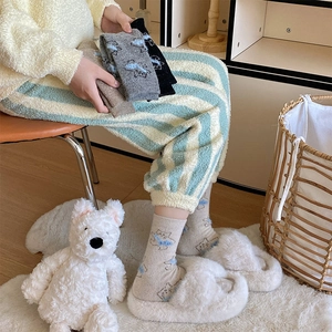 Close-up of cute cat jacquard pattern on plush thermal socks for women's home wear