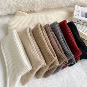 Detailed knit texture of rib-patterned cashmere socks in seven neutral autumn colors