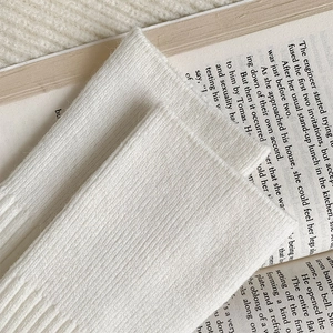 Close-up of white vertical ribbed knit texture on soft winter cashmere socks