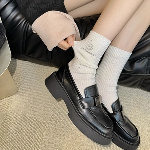 Women's warm wool socks with rhinestone accents paired with black leather loafers