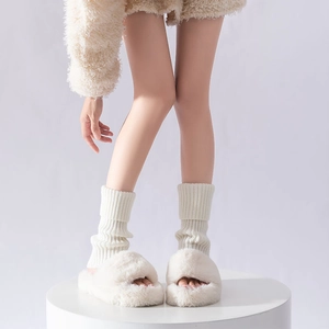 White faux fur platform slippers and ribbed knit leg warmers for a cozy winter style