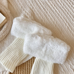 Detail of plush white faux fur trim and ribbed knit leg warmer for winter boots