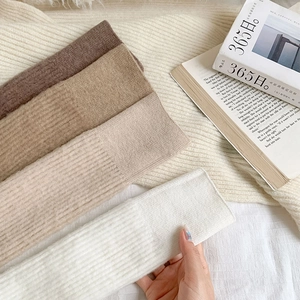Detailed texture of thick vertical ribbed knit cashmere socks in four earth tones
