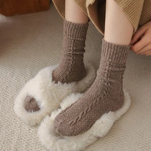 Detail of brown cable knit crew socks showing textured wool blend and warm thermal fabric