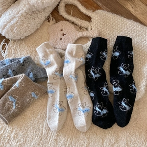 Detailed close-up showing thick knit wool socks with 3D blue fluffy cat patterns