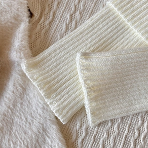 Macro shot of white ribbed knit cuff texture and premium fluffy fabric details