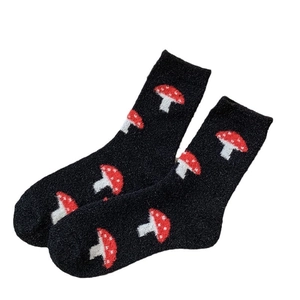 Thick warm crew socks for women featuring cute red mushroom patterns on black fuzzy fabric