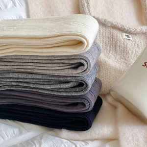 Close-up of thick ribbed knit calf socks in multiple colors with warm texture