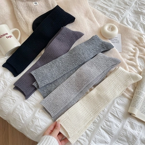 Detailed knit texture of vertical striped calf socks in four neutral classic colors