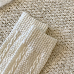 Detailed macro shot of cable knit wool texture and ribbed cuffs on winter socks