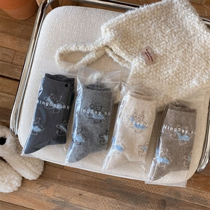 Detailed close-up of warm wool socks with cute cat prints and soft knitted texture