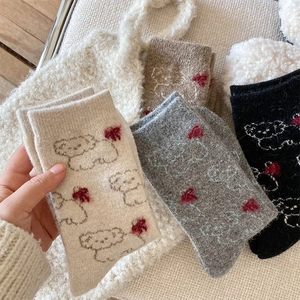 Close-up of thick wool socks with cute bear patterns and red hearts in four colors