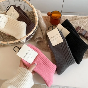 Detail of warm cashmere socks in five colors with vertical striped knit texture