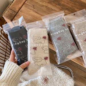 Close-up of winter wool socks with cute dog patterns in premium branded packaging