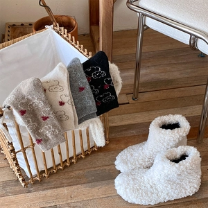 Cozy winter set with four pairs of heart pattern socks and fluffy white plush slippers