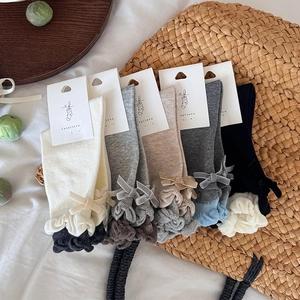 Detail of sweet bubble ruffle socks with velvet bows in five neutral colors