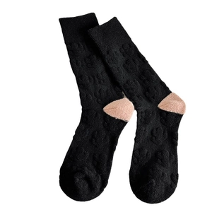 Black wool blend crew socks with pink heel contrast and embossed 3D paw print texture