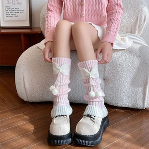 Détail de jambières Lolita rose et blanc avec nœuds doux et pompons en peluche mignons
