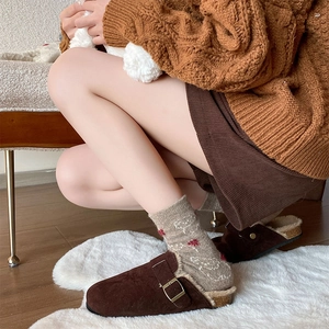 Brown suede mules with metal buckle and warm faux fur lining paired with floral socks
