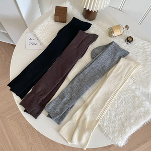 Chaussettes hautes côtelées en noir, marron, gris et crème disposées à plat