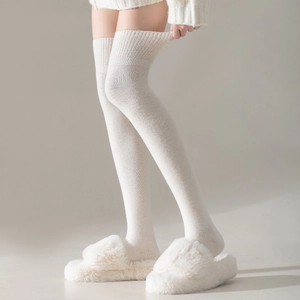 Détail de chaussettes hautes blanches en maille côtelée avec des chaussons confortables