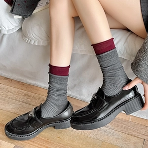 Vintage burgundy bow socks with striped edge paired with black patent leather loafers