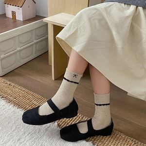 Japanese style frilly socks with bow embroidery and lace trim paired with black Tabi shoes