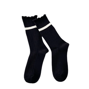 Japanese style black cotton crew socks with white striped ruffle trim and ribbed texture