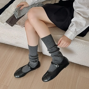 Detailed vertical ribbed texture of cotton blend slouch socks in multiple neutral colors