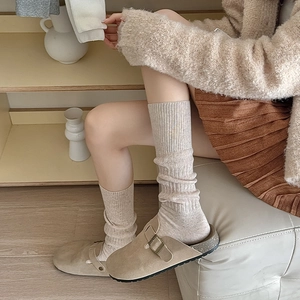 Japanese style khaki suede clogs with beige ribbed crew socks for a retro winter look