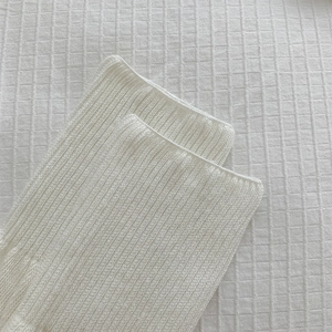 Detail of white rib-knit texture and fine stitching on JK style retro slouch socks