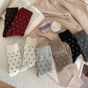 Flat lay of vintage polka dot wool socks in assorted colors for warm winter fashion