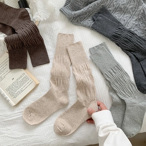Detail of multi-color ribbed slouch socks in brown and grey cotton knit fabric