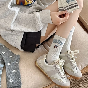 Detail of embroidered bear and striped rib-knit texture on soft cotton crew socks