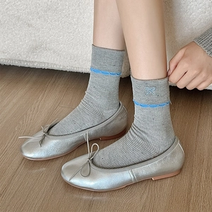 Silver ballet flats with bow and grey crew socks featuring blue butterfly embroidery