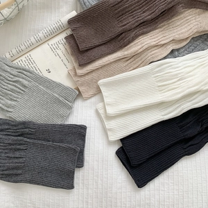 Detailed knit texture of vintage style ribbed leg warmers in six earthy colors