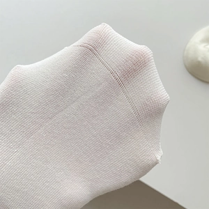Close-up of breathable white mesh knit fabric with high elasticity and fine texture