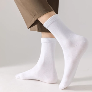 Close-up of white mid-calf cotton socks featuring a comfortable ribbed cuff design