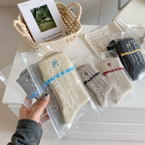 Close-up of ballet-style socks with bow embroidery and wavy cuffs in multi-color gift set