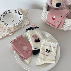 Close-up of cute cotton mid-calf socks with bow embroidery and rabbit patterns